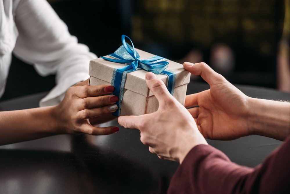 handing gift to someone