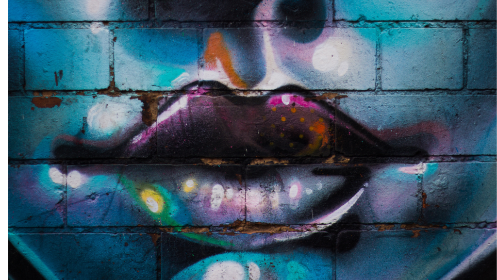 lips painting on a bricked wall