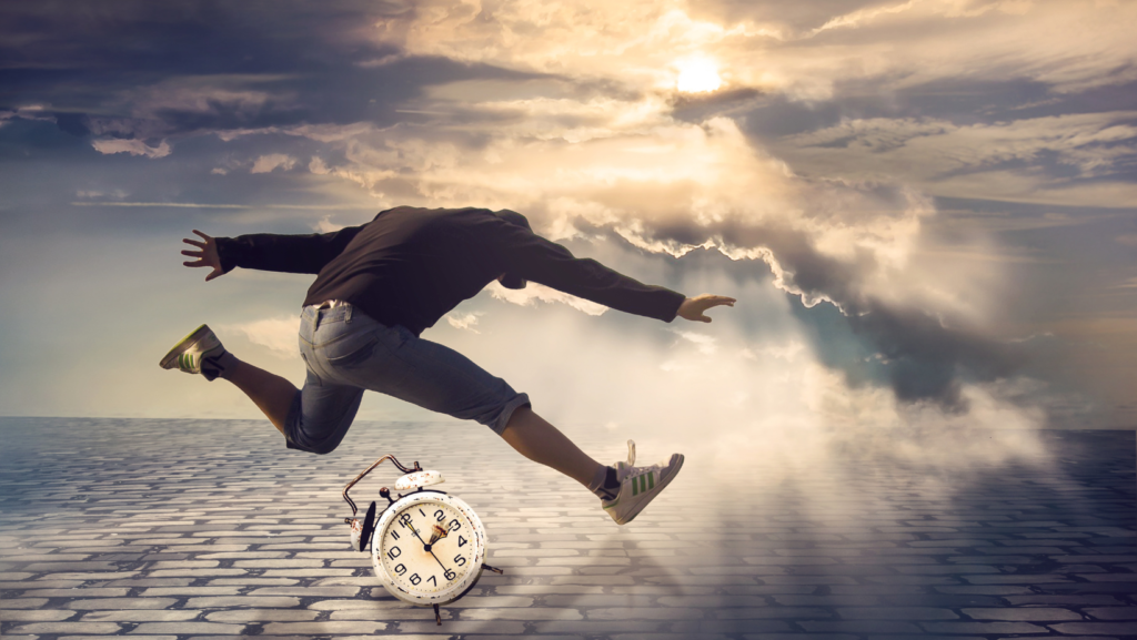 man in air with hands and legs spread out with a clock underneath him in background of shining clouds