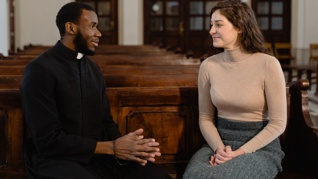 man of faith inside a church talking to a woman