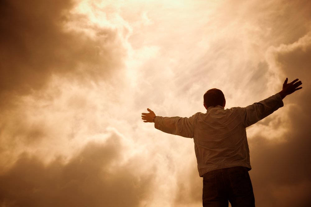 man and dramatic clouds, religion concept, selective focus