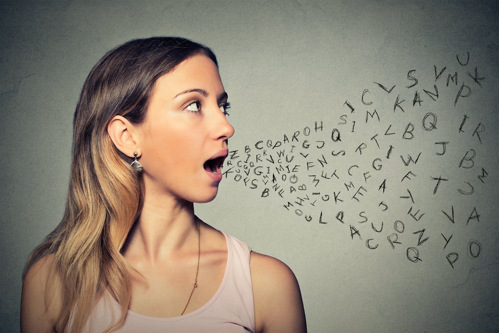 Woman talking with alphabet letters coming out of her mouth. Communication, information, intelligence concept